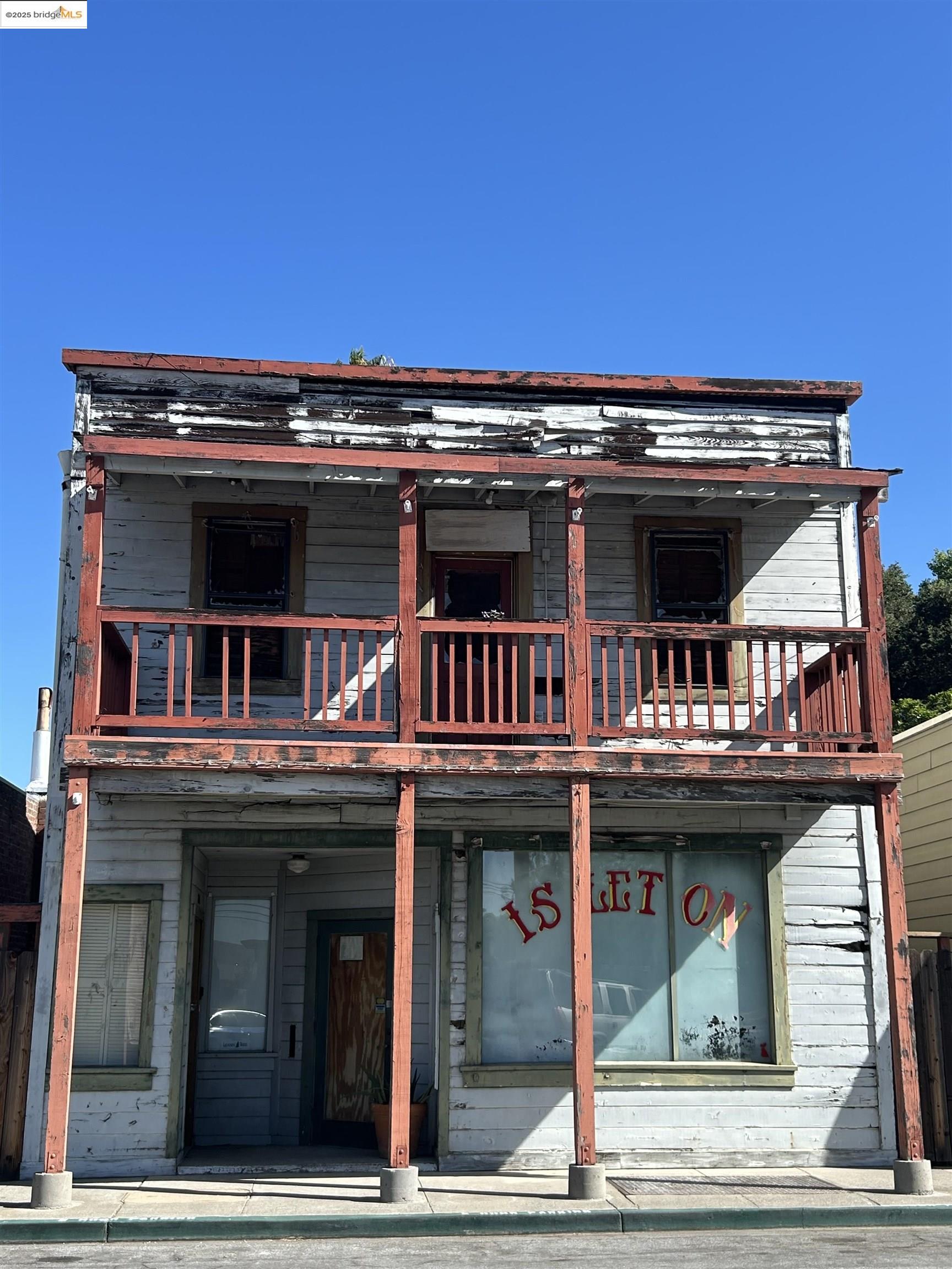 Back of house featuring a balcony