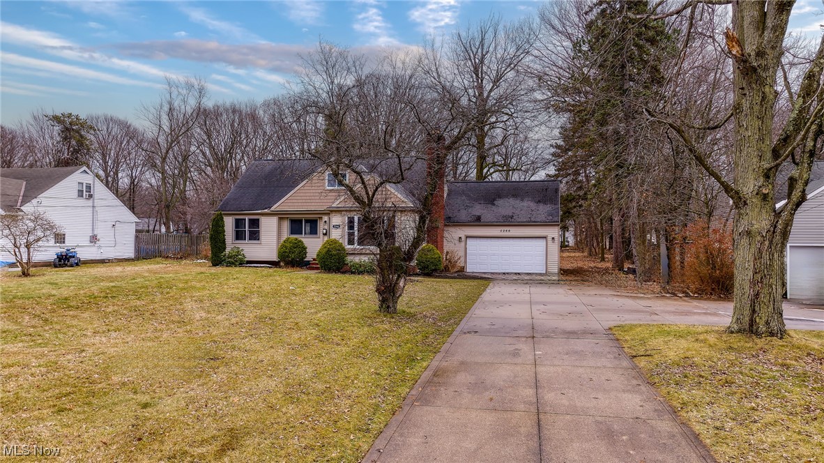 5266 Wilson Mills Road Cleveland, OH 44143 - Photo 40 of 50 Cape cod-style house featuring a front lawn, driveway, roof with shingles, and a garage