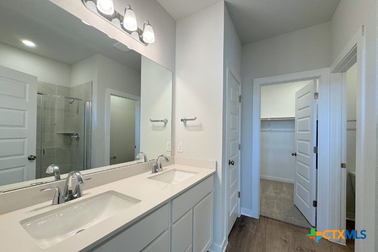 260 Escape Way Jarrell, TX 76537 - Photo 5 of 12 a bathroom with a sink double vanity and shower