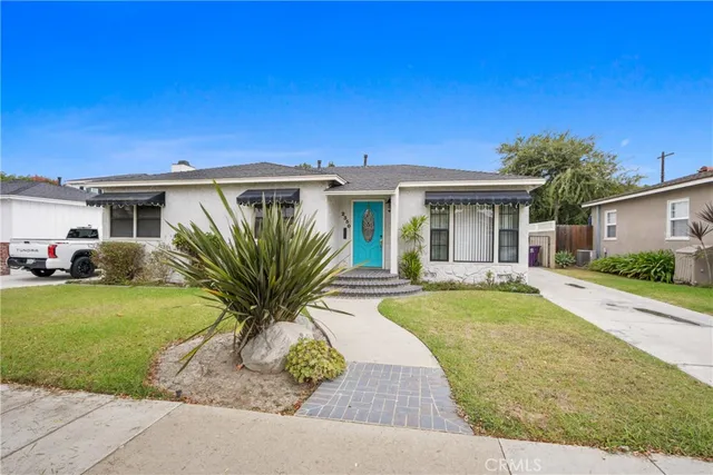 a view of a white house with a yard