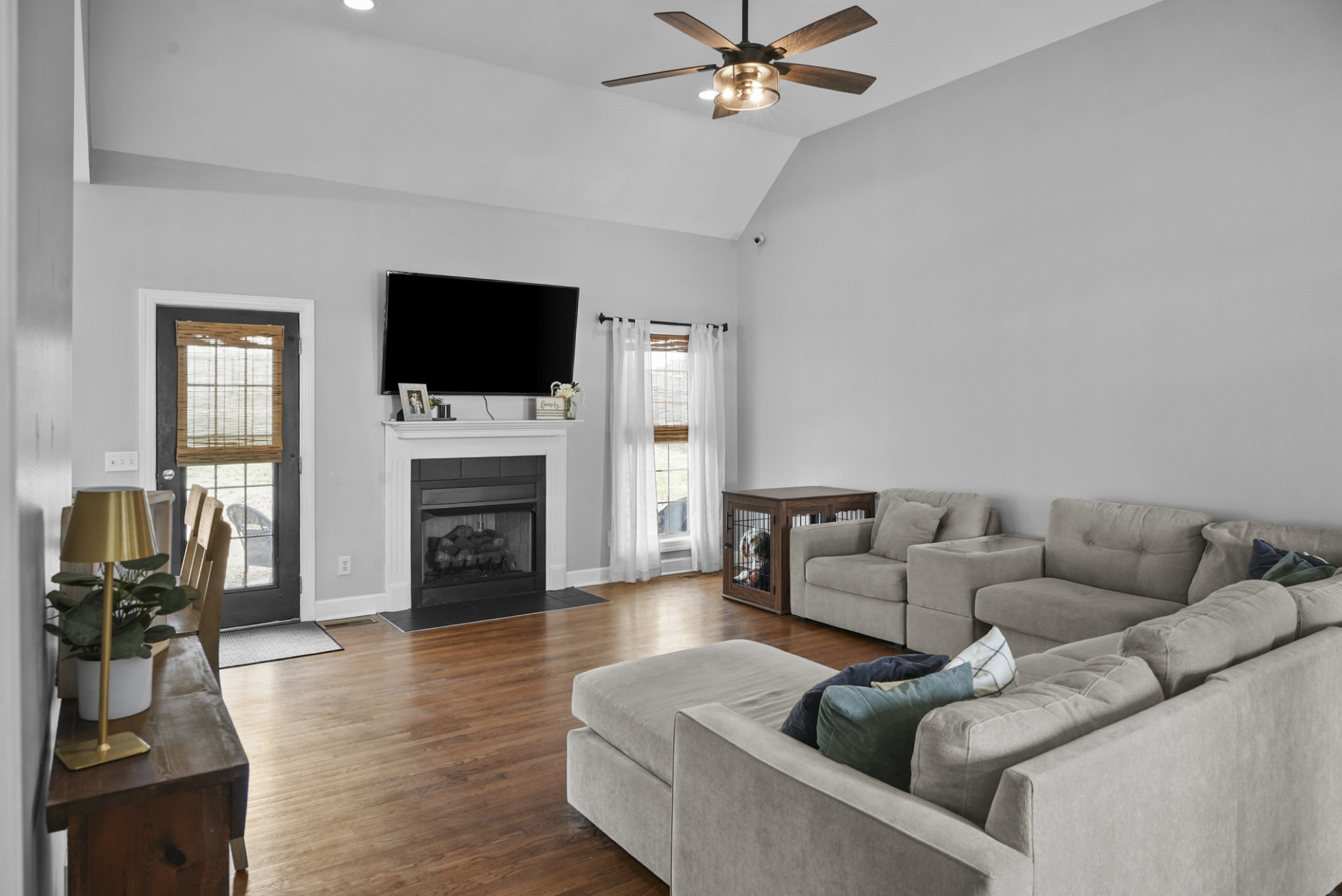 1191 Filmore Harris Road Pleasant View, TN 37146 - Photo 4 of 24 a living room with furniture a fireplace and a flat screen tv