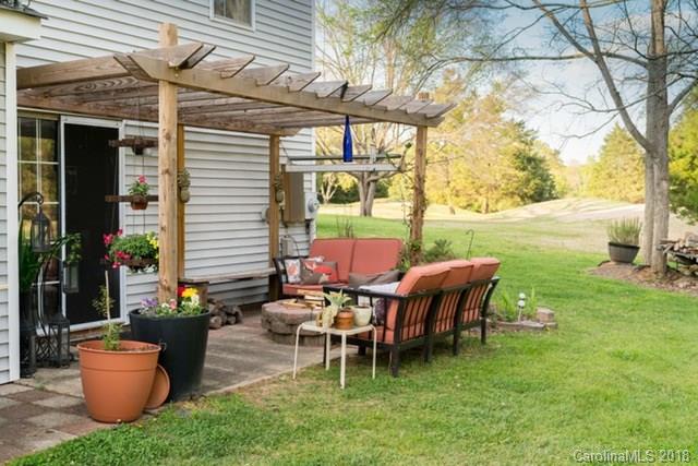 8209 Golf Ridge Drive Charlotte, NC 28277 - Photo 4 of 21 a view of a patio with table and chairs potted plants and a large tree