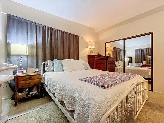 a bedroom with bed and wooden furniture