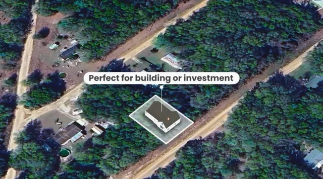 a sign that is sitting on a wooden fence