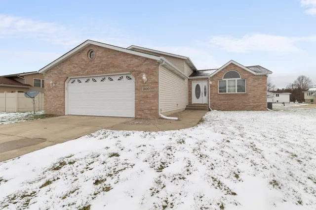 a view of a house with a snow on the side of the road