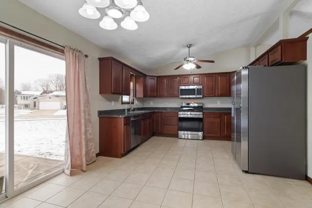 a bathroom with a granite countertop sink a large mirror and a bathtub