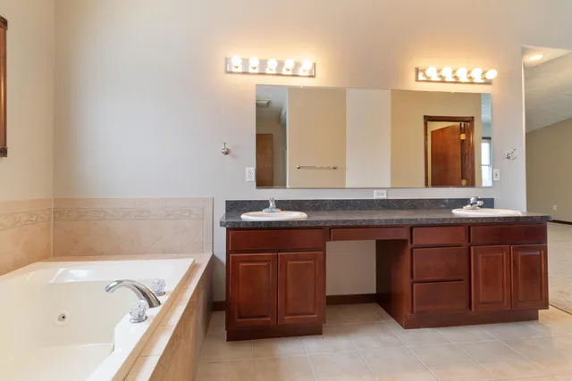 a view of a kitchen with a refrigerator and a stove top oven