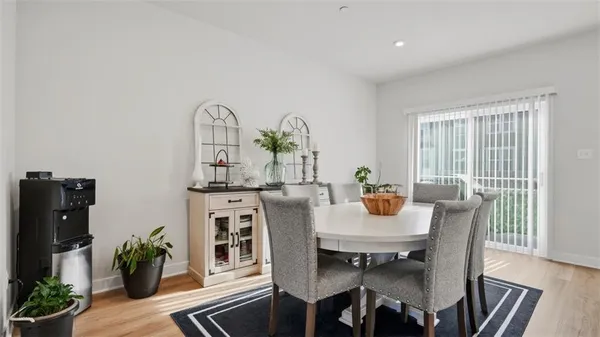 a view of a dining room with furniture window and wooden floor