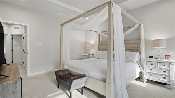 a view of a bedroom with furniture and windows