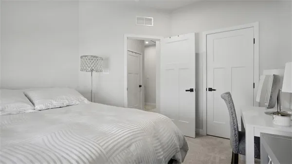 a bedroom with a bed and a chair