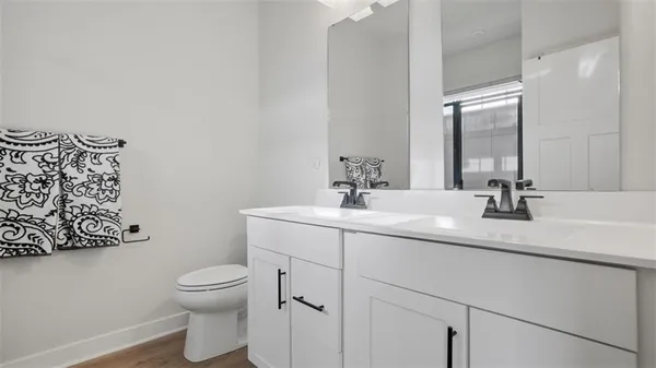 a bathroom with a toilet sink and mirror