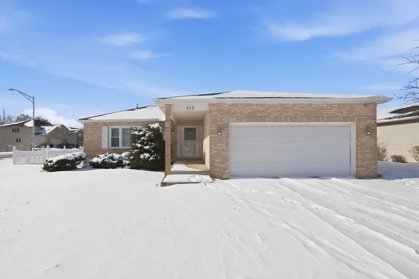 a view of house with yard and covered with snow