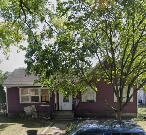 a view of a house with a tree