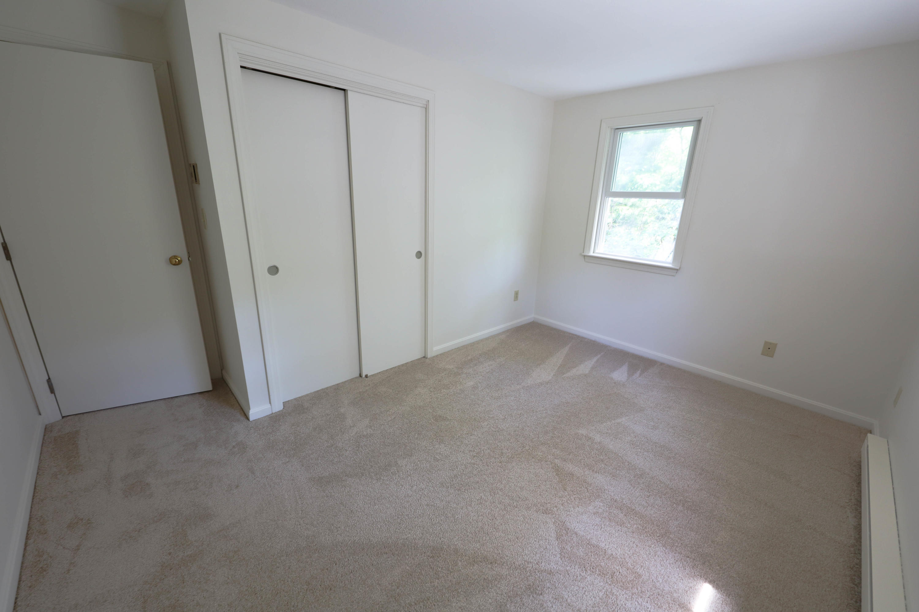 91 Quashnet Road Mashpee, MA 02649 - Photo 11 of 16 an empty room with windows