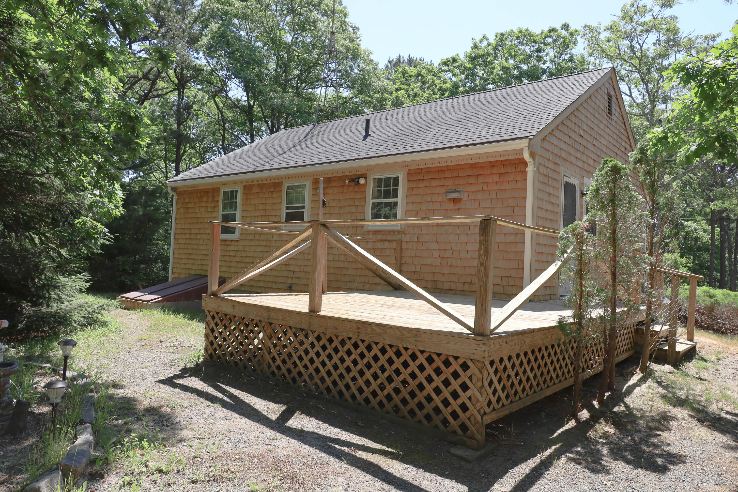 91 Quashnet Road Mashpee, MA 02649 - Photo 2 of 16 a front view of a house with garden