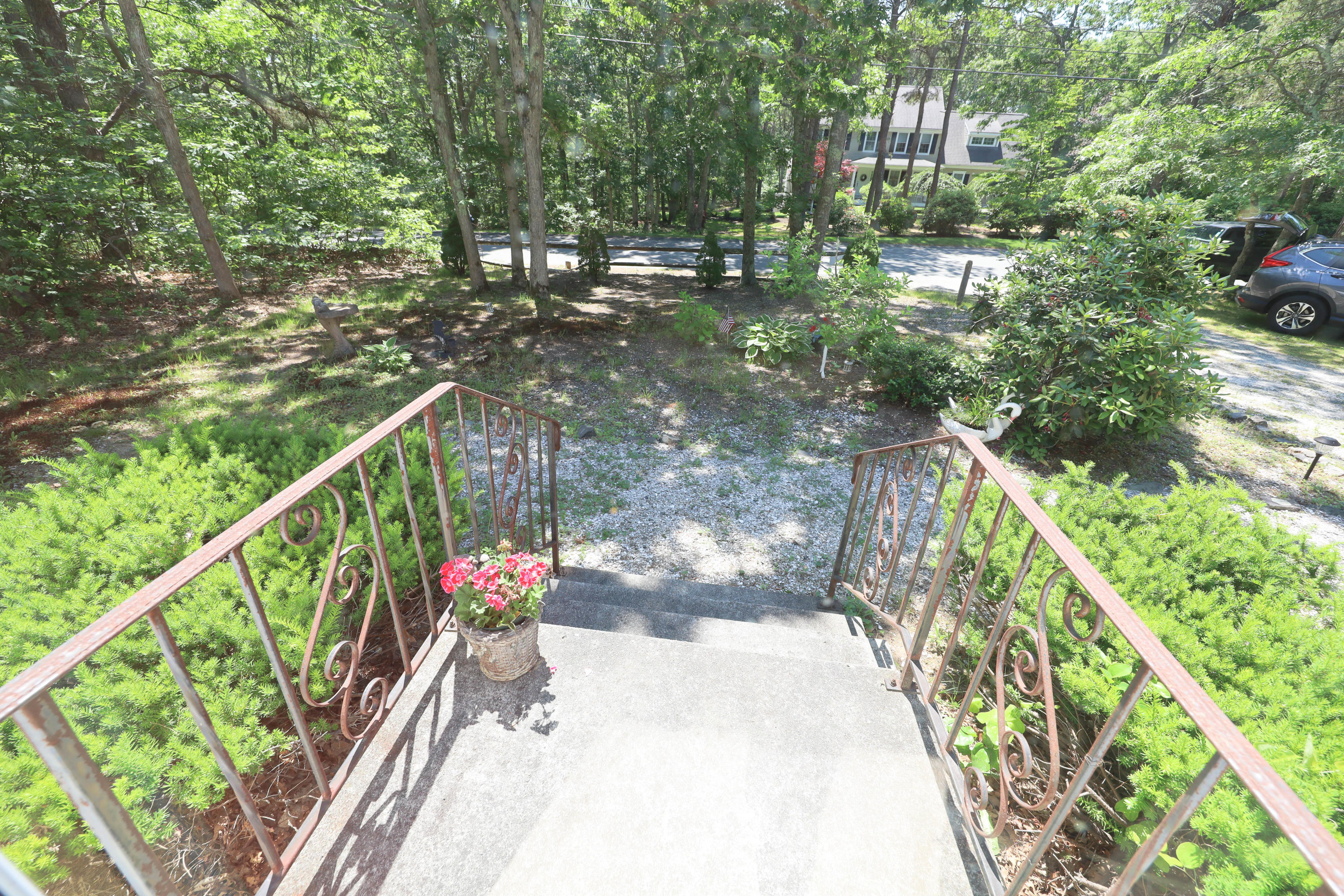 91 Quashnet Road Mashpee, MA 02649 - Photo 3 of 16 a view of street with lots of trees
