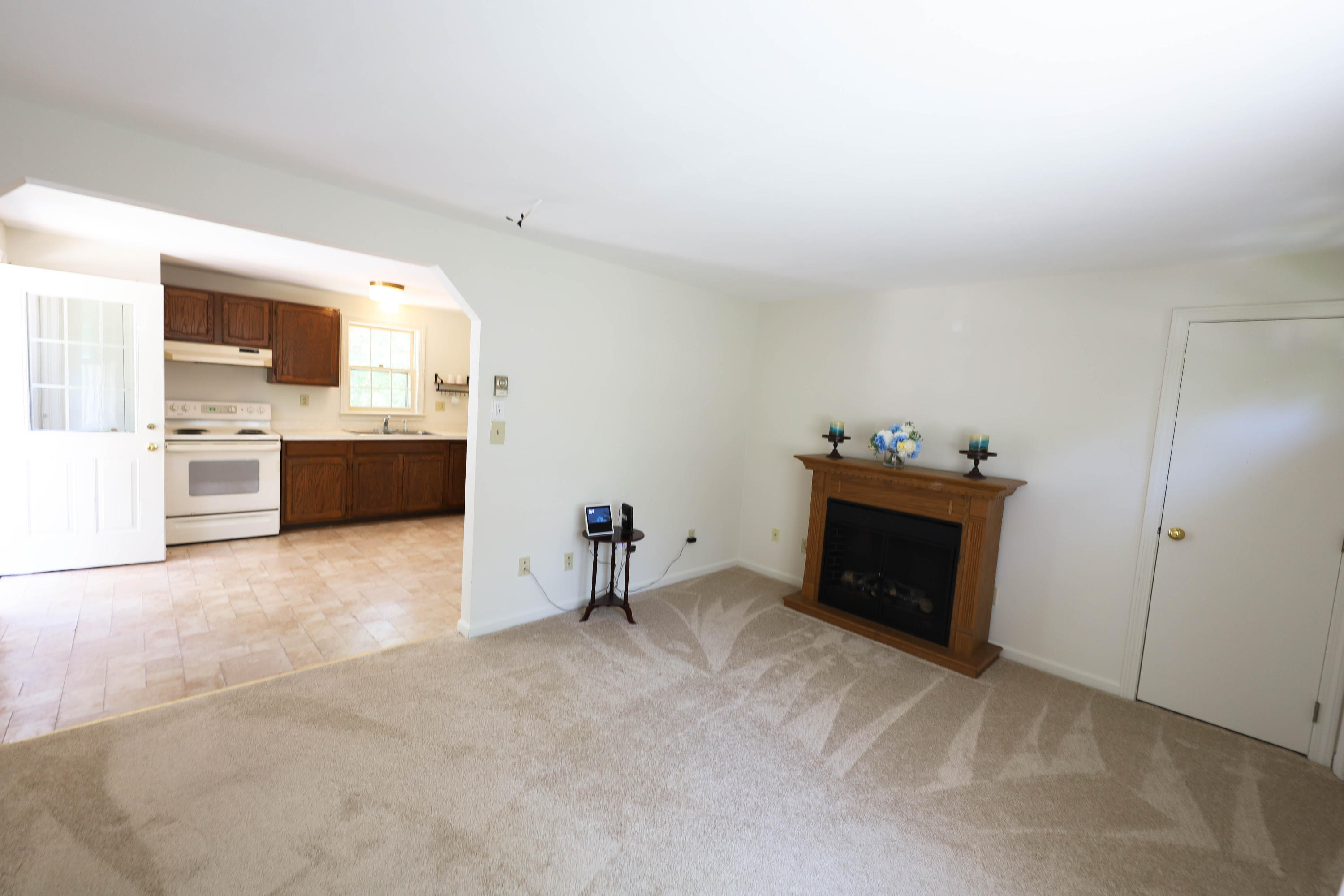 91 Quashnet Road Mashpee, MA 02649 - Photo 6 of 16 a view of a kitchen with microwave and furniture