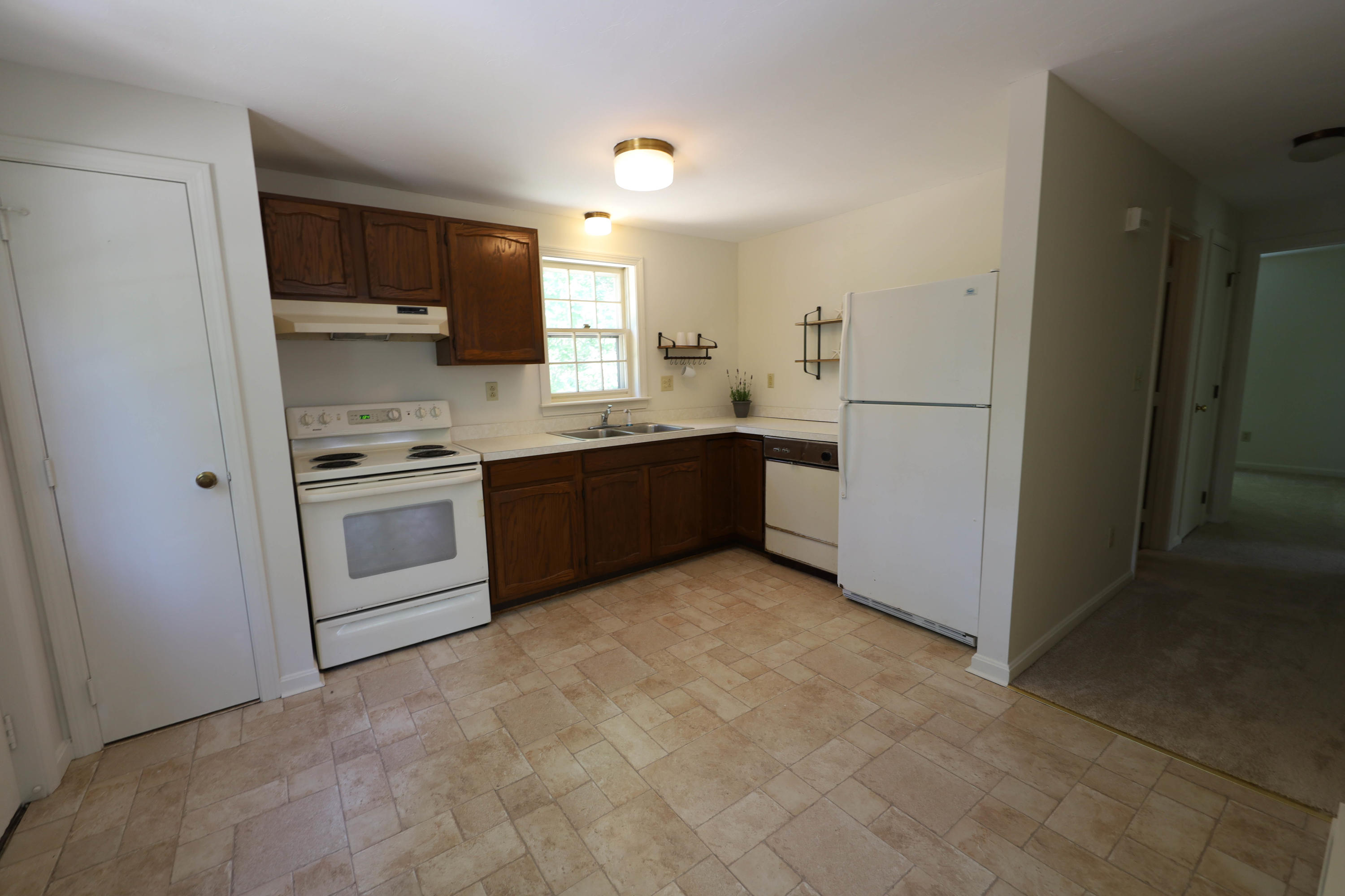 91 Quashnet Road Mashpee, MA 02649 - Photo 7 of 16 a kitchen with stainless steel appliances granite countertop a stove a sink and a refrigerator