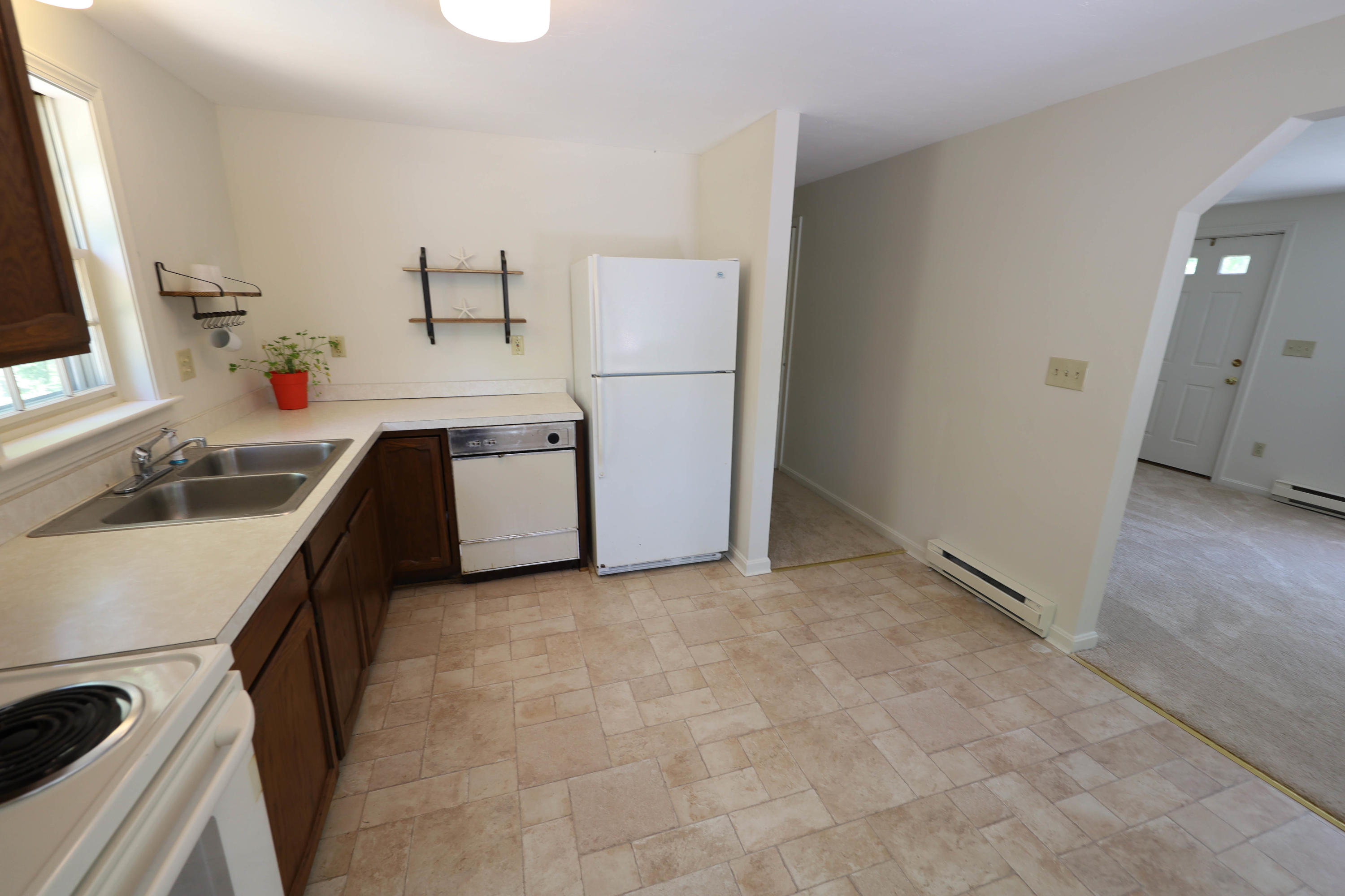 91 Quashnet Road Mashpee, MA 02649 - Photo 8 of 16 a kitchen with a sink stove and refrigerator