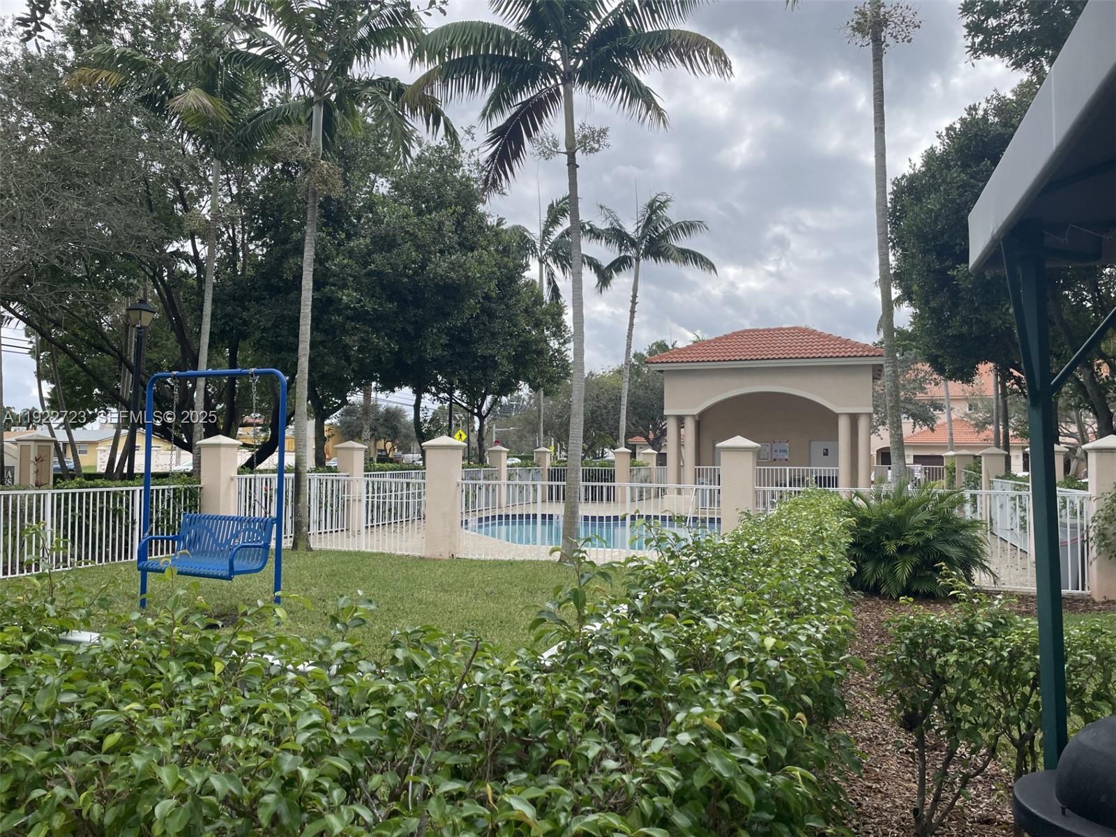 8831 South Isles Circle, Unit 8831 Tamarac, FL 33321 - Photo 1 of 22 a front view of a house with a garden