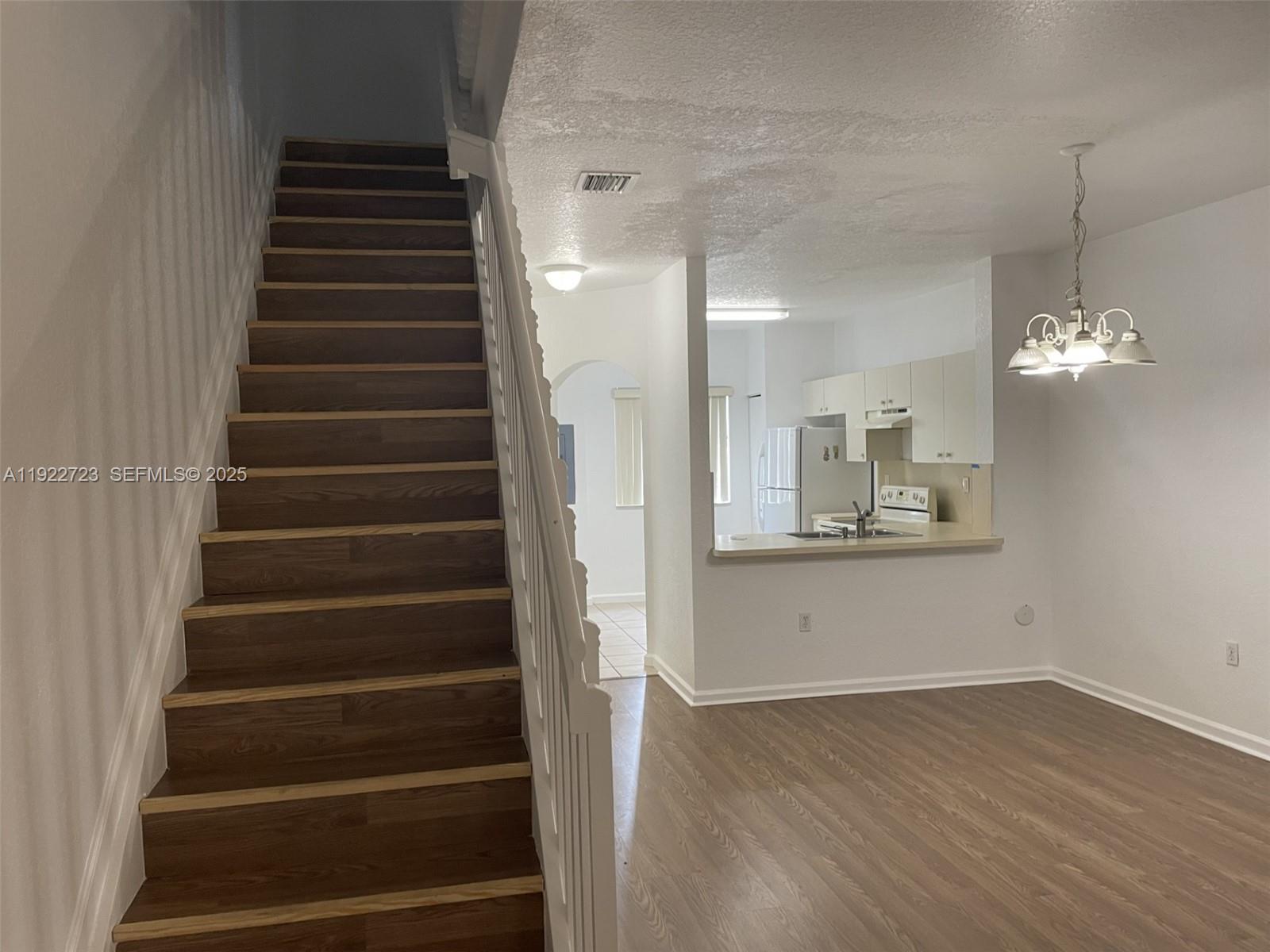 8831 South Isles Circle, Unit 8831 Tamarac, FL 33321 - Photo 13 of 22 a view of an entryway with wooden floor and staircase