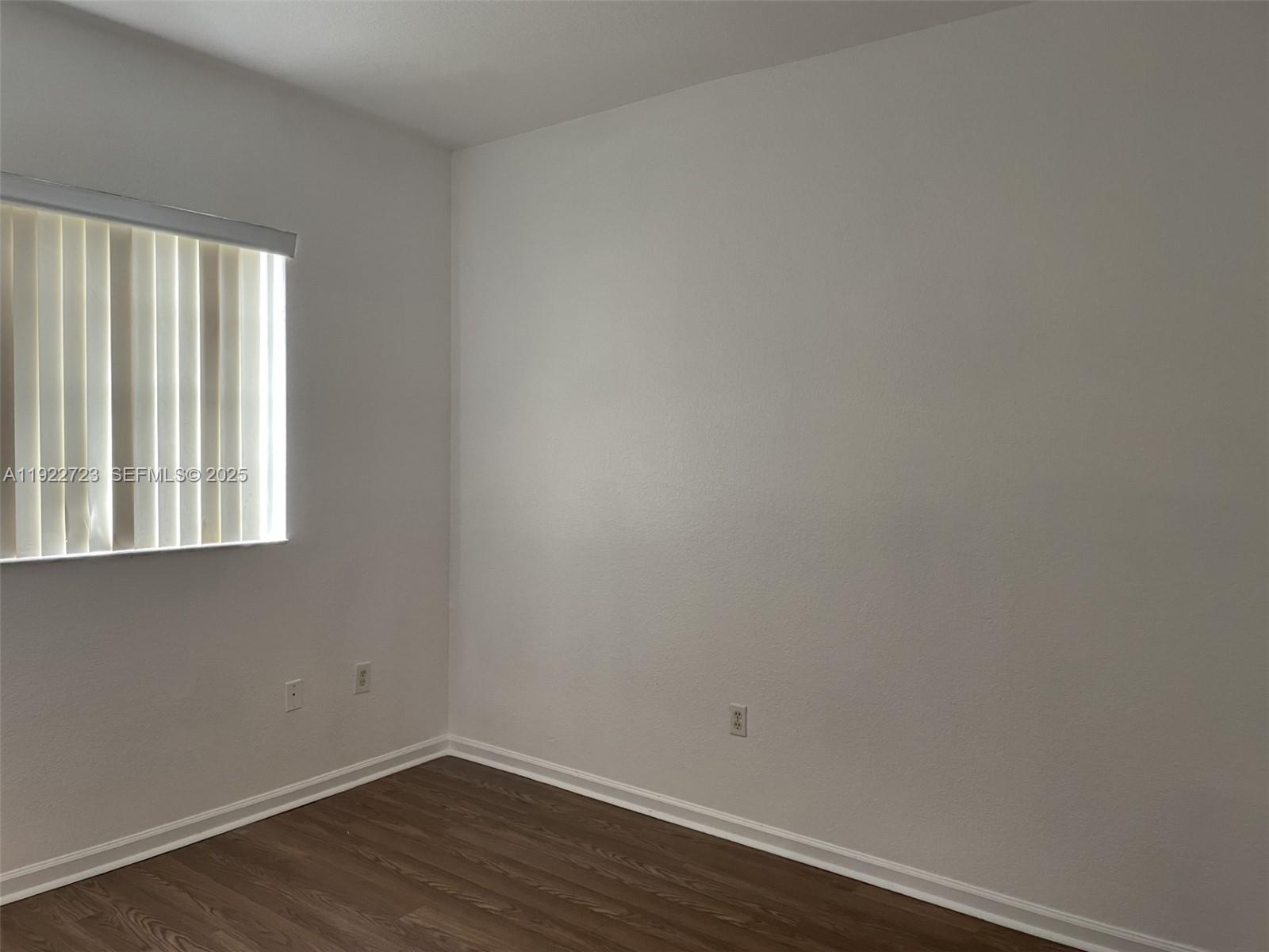 8831 South Isles Circle, Unit 8831 Tamarac, FL 33321 - Photo 16 of 22 a view of a small space with wooden floor and a window