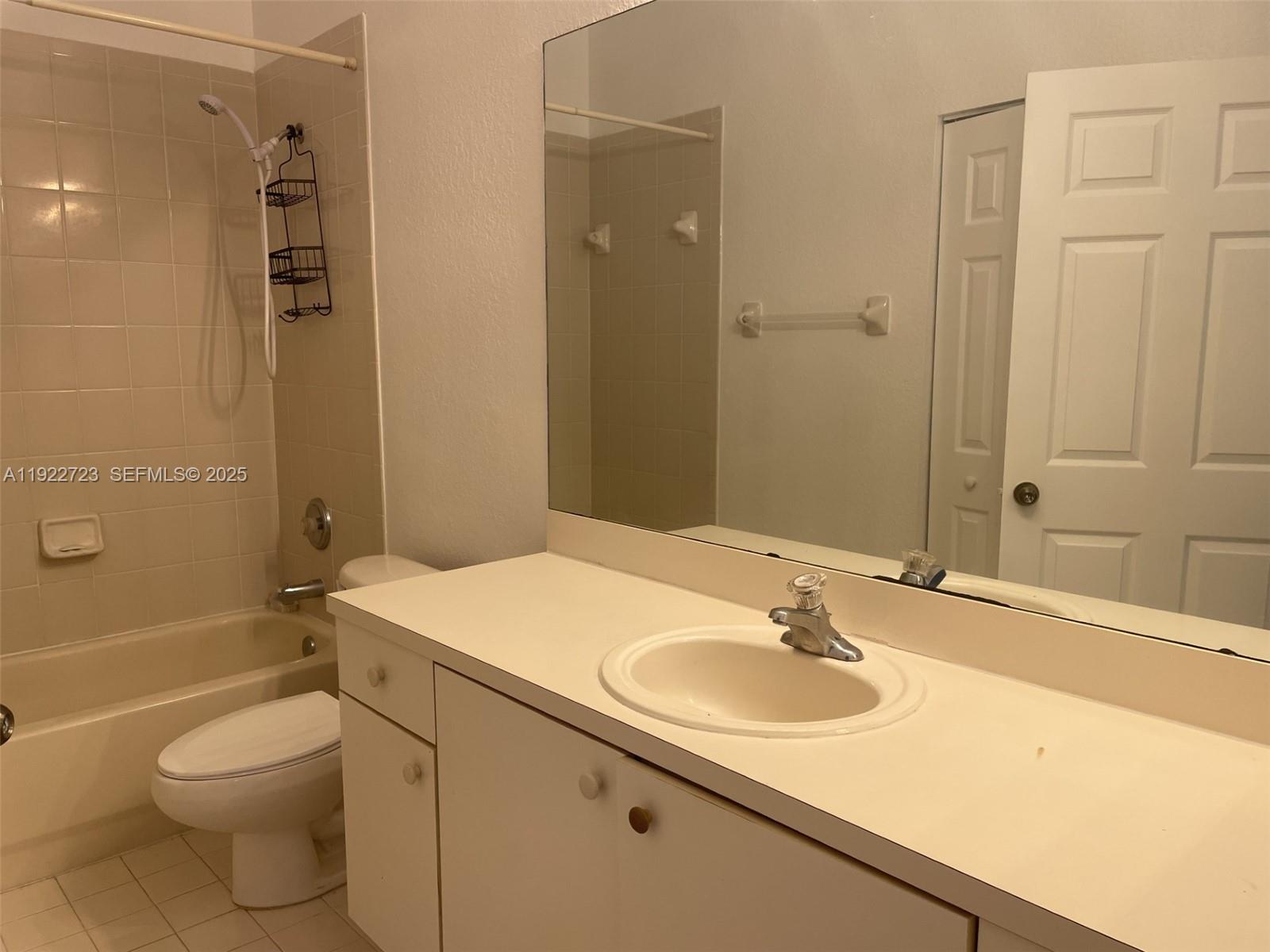 8831 South Isles Circle, Unit 8831 Tamarac, FL 33321 - Photo 18 of 22 a bathroom with a sink toilet and shower