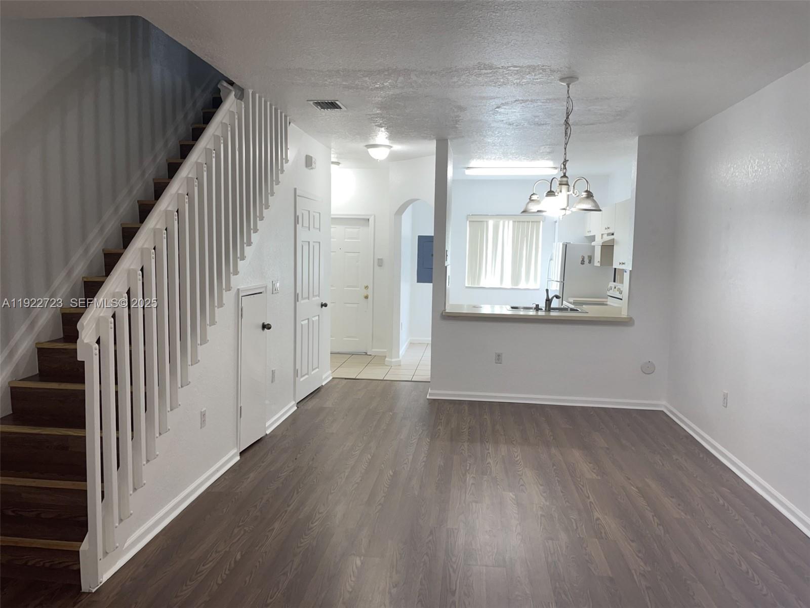 8831 South Isles Circle, Unit 8831 Tamarac, FL 33321 - Photo 21 of 22 a view of a hallway with wooden floor and staircase