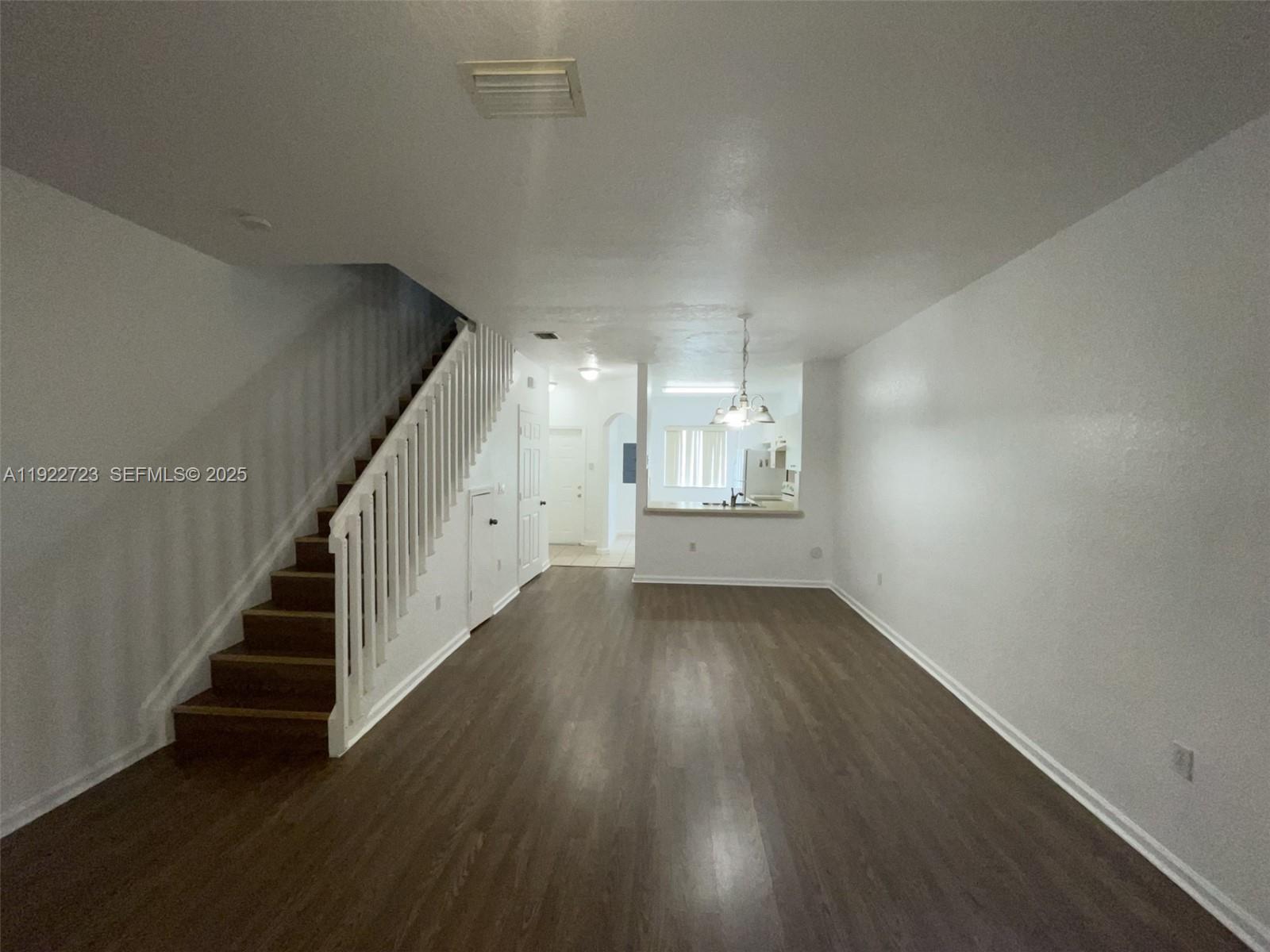 8831 South Isles Circle, Unit 8831 Tamarac, FL 33321 - Photo 22 of 22 a view of an empty room with wooden floor and stairs
