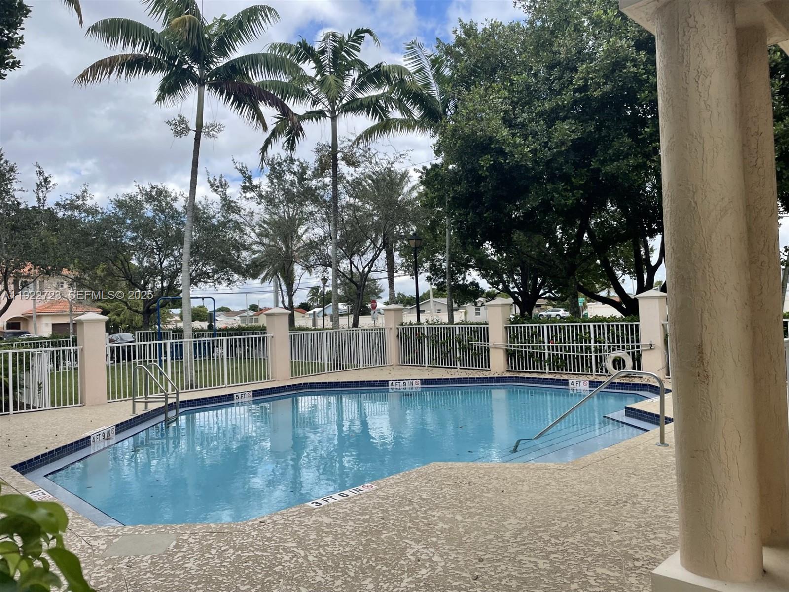 8831 South Isles Circle, Unit 8831 Tamarac, FL 33321 - Photo 6 of 22 a view of a lake with a house in the background