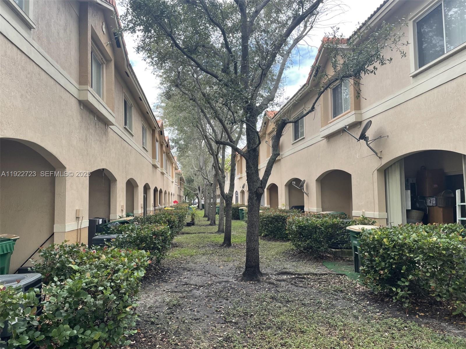 8831 South Isles Circle, Unit 8831 Tamarac, FL 33321 - Photo 7 of 22 a front view of a house with garden