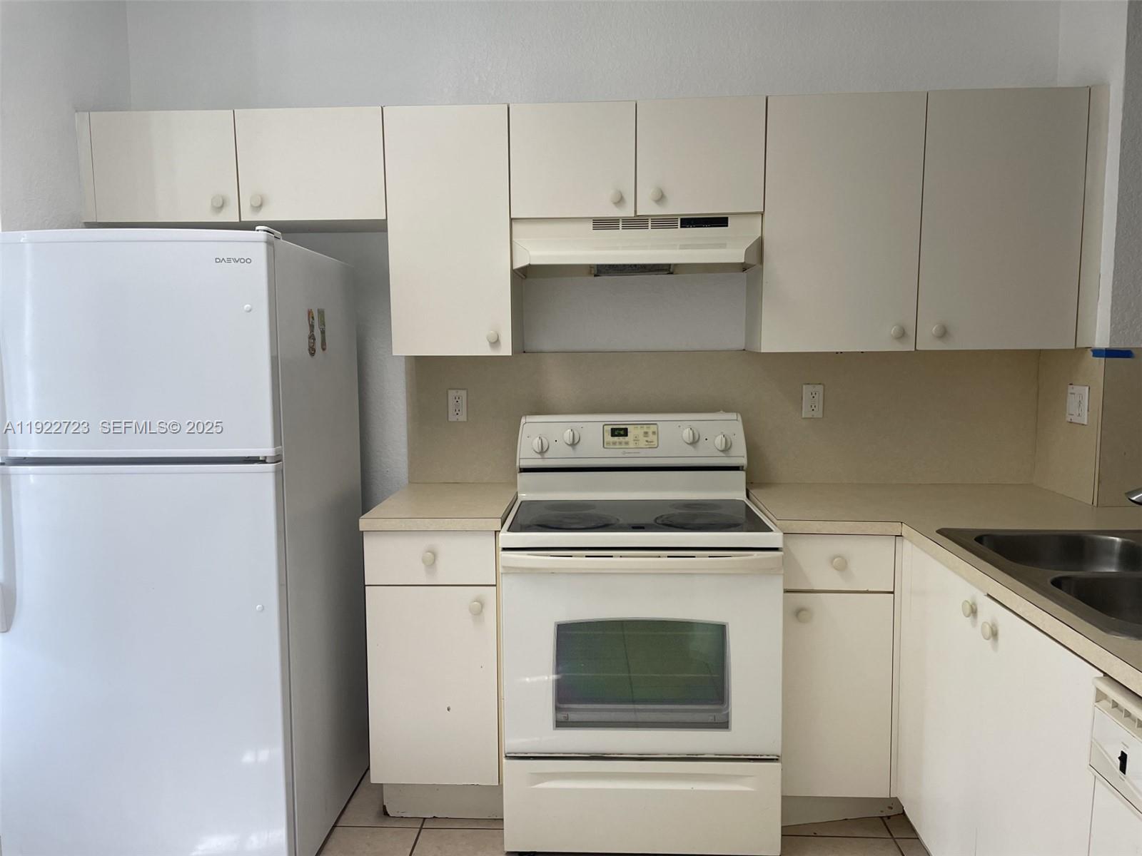 8831 South Isles Circle, Unit 8831 Tamarac, FL 33321 - Photo 10 of 22 a view of a kitchen with washer and dryer