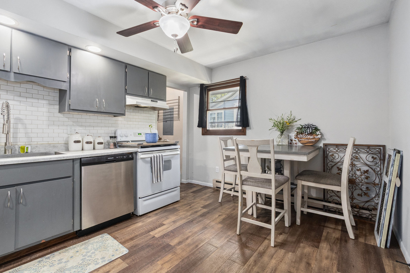 309 South Joliet Street, Unit 309 Wilmington, IL 60481 - Photo 6 of 12 a kitchen with stainless steel appliances a table chairs refrigerator and cabinets
