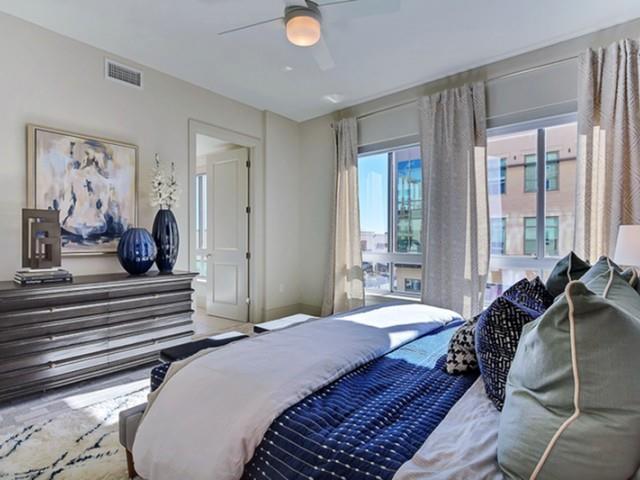 7775 Firefall Way, Unit 2700 Dallas, TX 75230 - Photo 6 of 23 a bedroom with a bed and a large mirror on the dresser