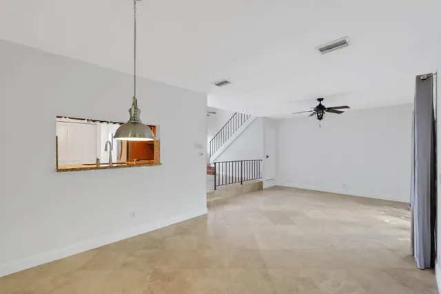 a kitchen with granite countertop a sink and cabinets