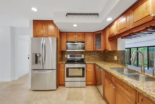 a bathroom with a granite countertop sink a toilet and shower