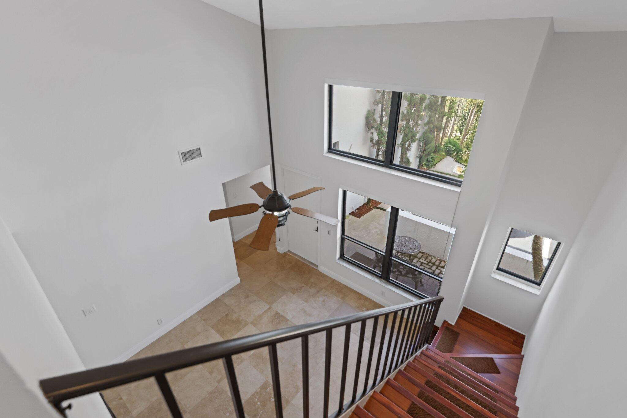 361 West Camino Real, Unit 9 Boca Raton, FL 33432 - Photo 19 of 37 a view of a hallway with wooden floor and stairs