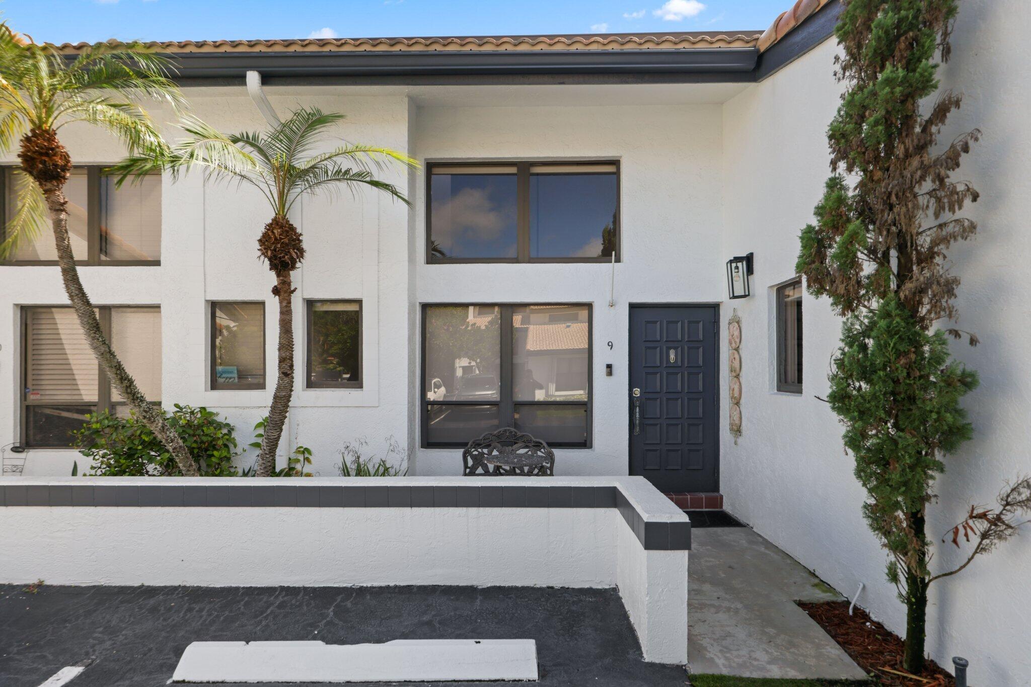 361 West Camino Real, Unit 9 Boca Raton, FL 33432 - Photo 2 of 37 a view of a house with a window and potted plants