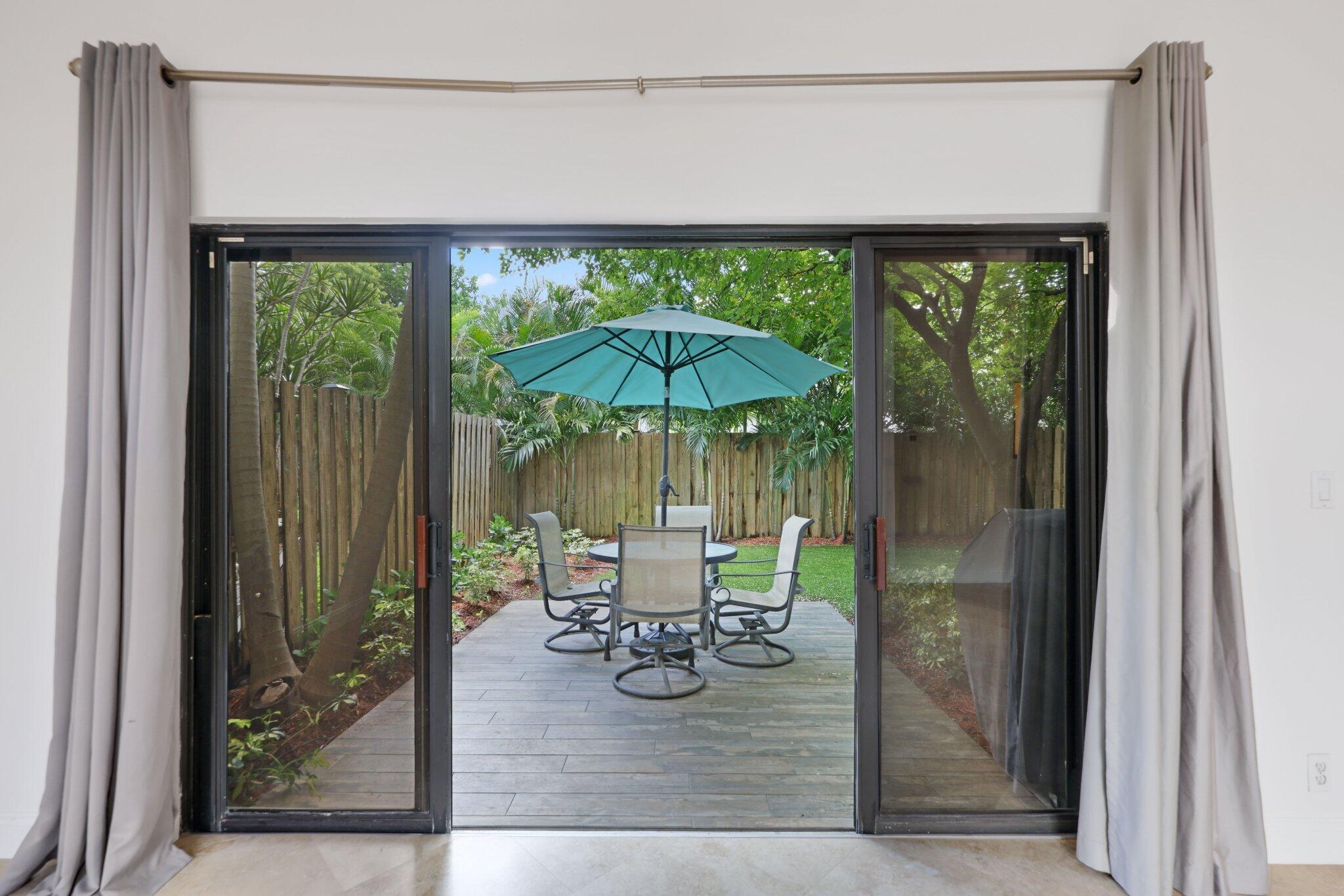 361 West Camino Real, Unit 9 Boca Raton, FL 33432 - Photo 25 of 37 a dining room with a wooden table and chairs