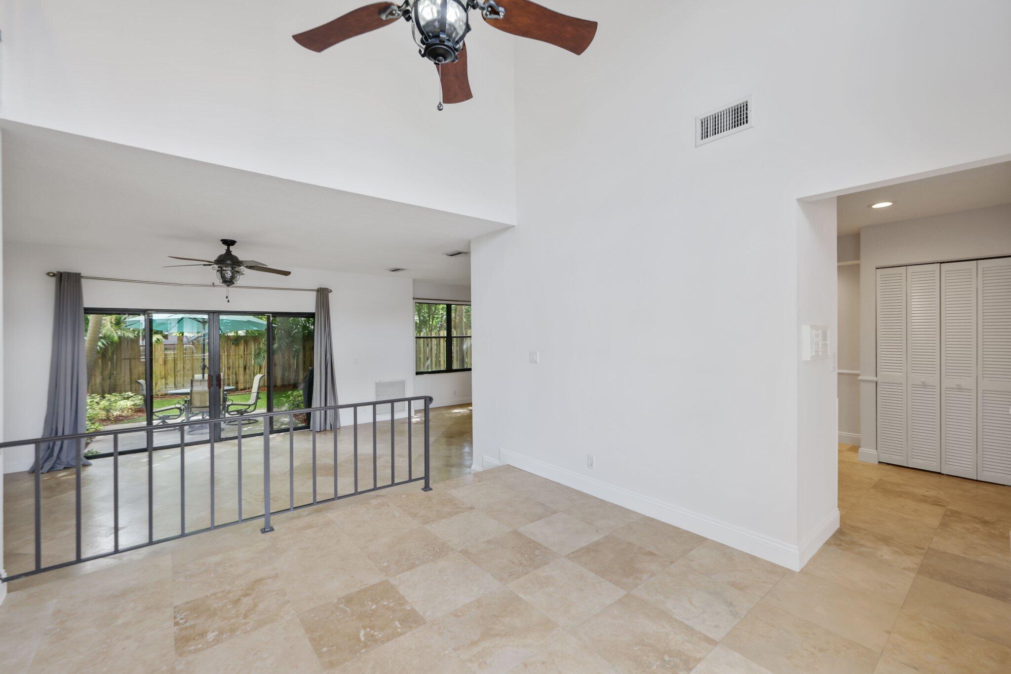 361 West Camino Real, Unit 9 Boca Raton, FL 33432 - Photo 7 of 37 en view interior of a house wooden floor ceiling fan and windows