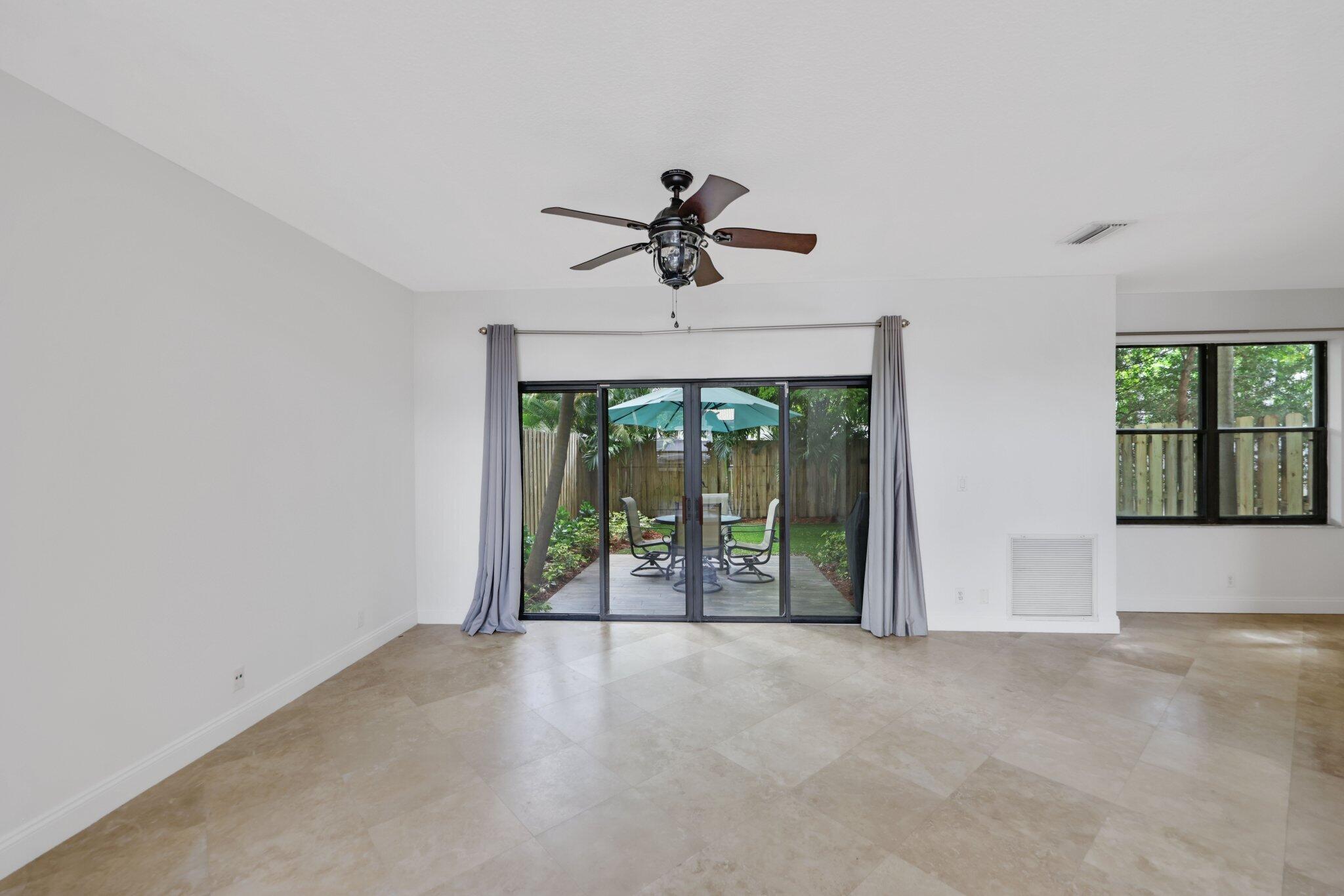 361 West Camino Real, Unit 9 Boca Raton, FL 33432 - Photo 8 of 37 wooden floor in an empty room with a window