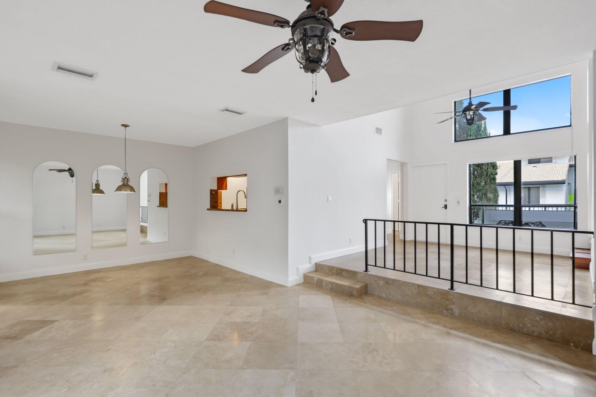 361 West Camino Real, Unit 9 Boca Raton, FL 33432 - Photo 9 of 37 a view of a livingroom with a ceiling fan and window