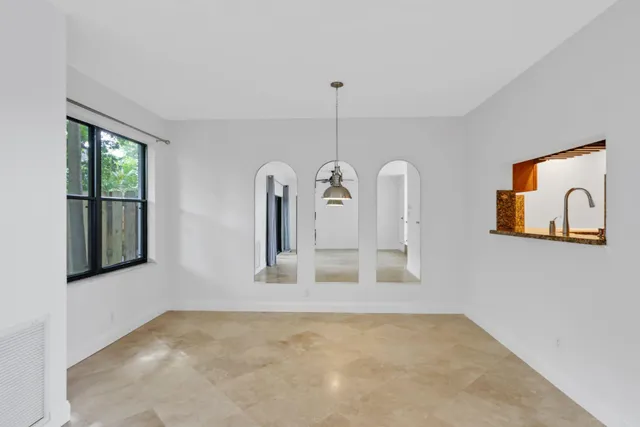 a kitchen with stainless steel appliances granite countertop a refrigerator a sink dishwasher a stove with white cabinets and wooden floor