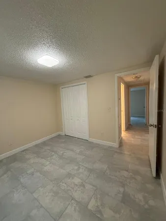 a bathroom with a granite countertop toilet a sink and mirror