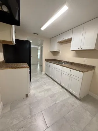 a kitchen with a refrigerator and cabinets