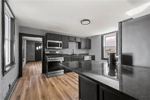 a kitchen with refrigerator and microwave