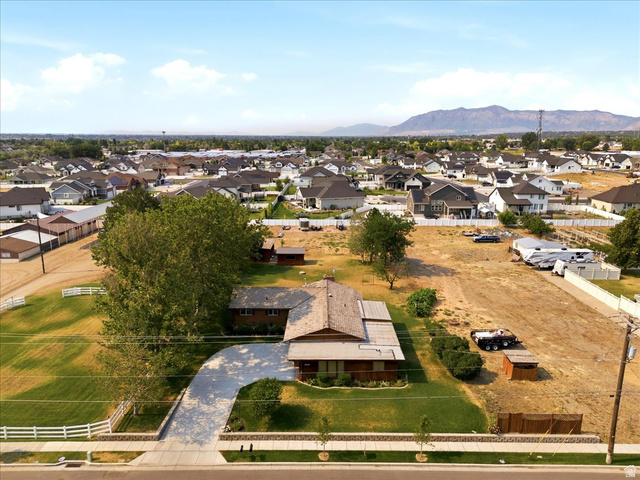 2252 West 800 North Clinton, UT 84015 - Photo 33 of 38 Expansive property featuring a paved driveway, mature trees, and a surrounding neighborhood