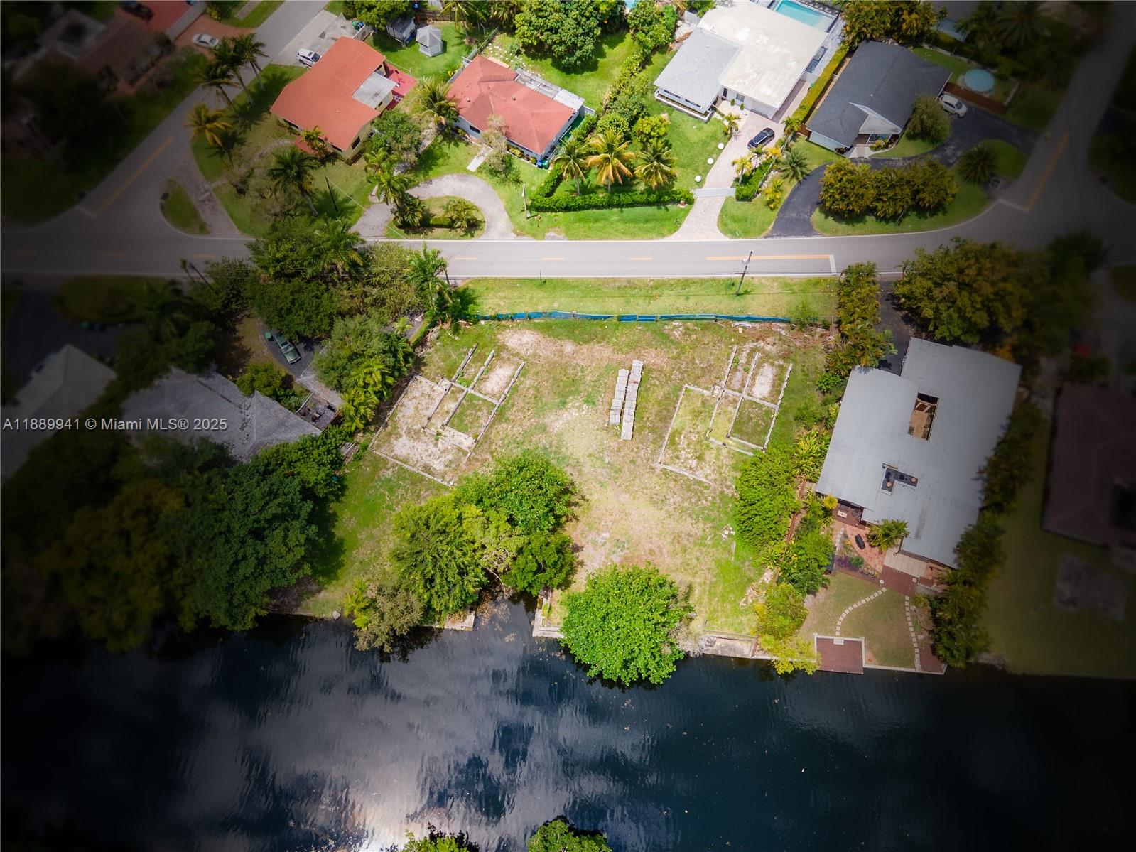 11595 West Biscayne Canal Road Miami, FL 33161 - Photo 14 of 14 an aerial view of a house with a garden and a yard