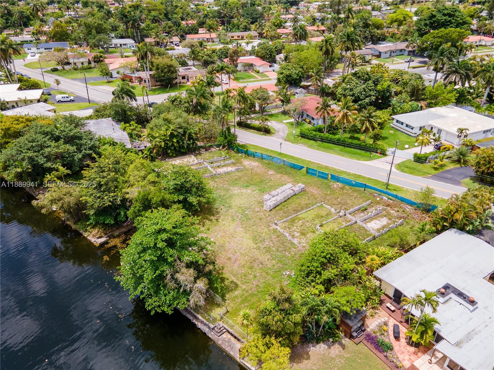 11595 West Biscayne Canal Road Miami, FL 33161 - Photo 9 of 14 an aerial view of residential houses with outdoor space and trees