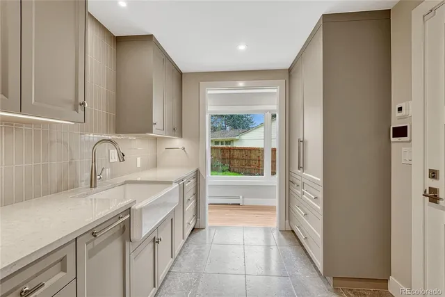 a kitchen with a sink and a refrigerator